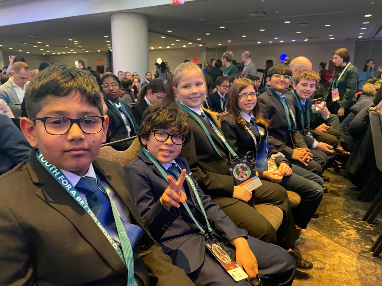 Hudson Montessori students sit in a row during MMUN meeting. 