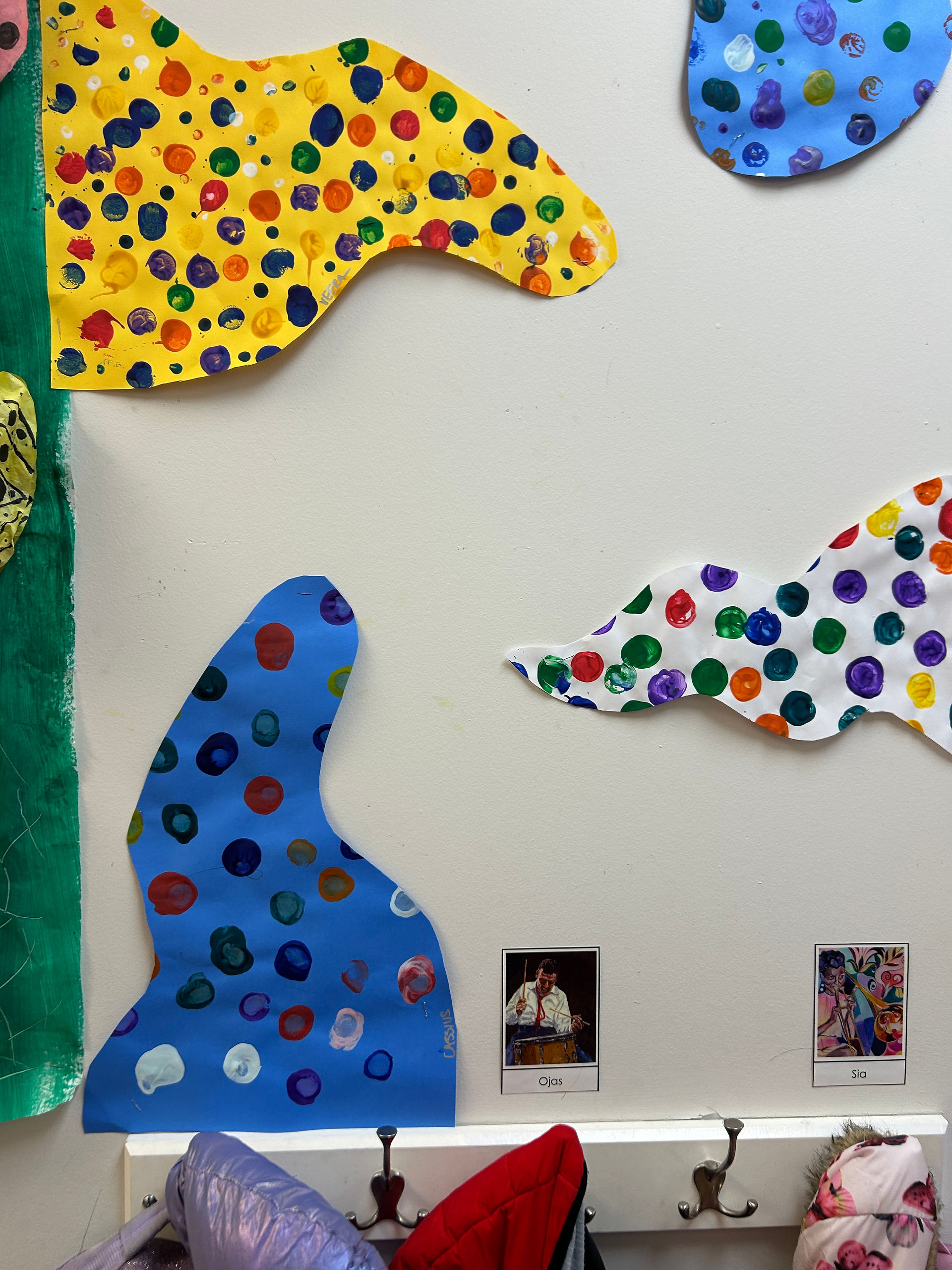 Abstract shapes colored in with polka dots inspired by Yayoi Kusama artwork made by primary students. 