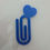 Miniature : Blue heart-shaped paper clip on white surface, office accessory, Sélenite.