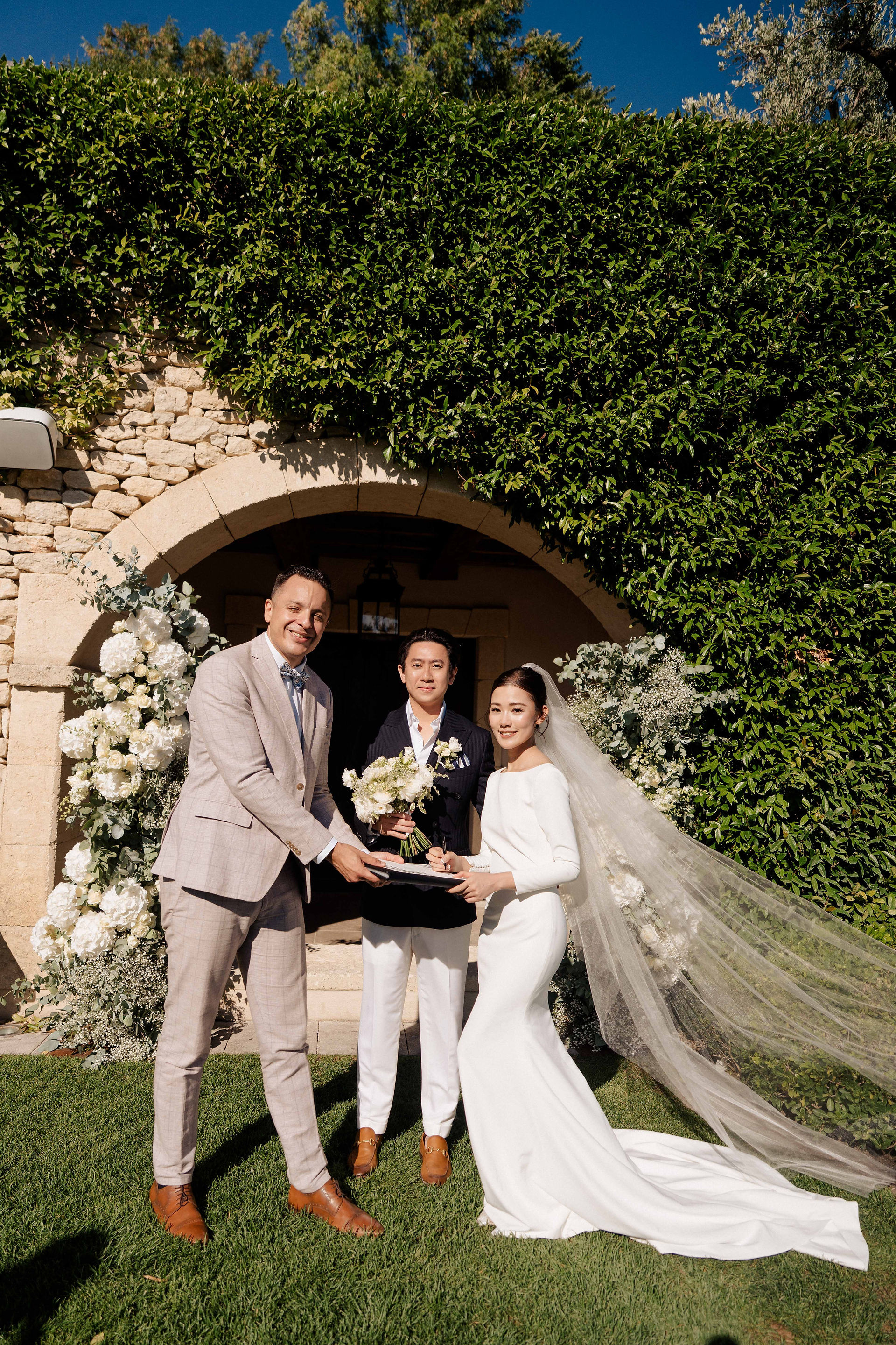 Officiant handing over the elopement document to the bride and the groom