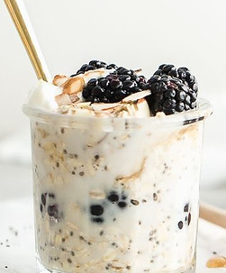 A yogurt parfait with sliced almonds, greek yogurt, blackberries and manuka honey as a healthy and nutritious breakfast or mid-day option