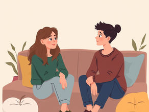 Two people sit on a cozy sofa, engaging in an open and supportive conversation about the need for more family support, surrounded by cushions and plants for a warm ambiance.