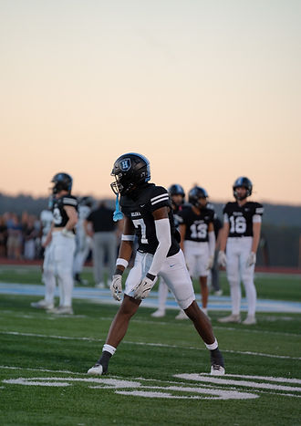 An athlete in the middle of a football game being naturally captured in Alabama
