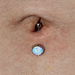 Fresh Lower Navel Piercing with a White Opal Cabochon bottom Titanium Navel Curve (Top Down View)