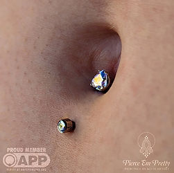 Fresh Lower Navel Piercing with an Aurora Borealis Gemmed Heart Set Titanium Navel Curve (Side)