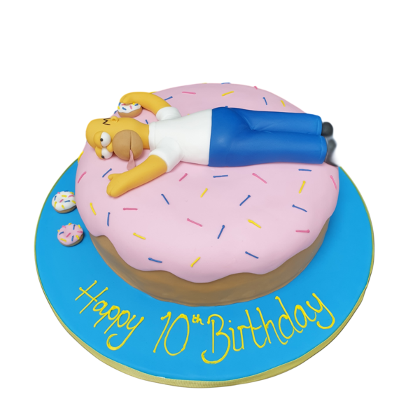 A tempting and indulgent donut-shaped cake inspired by Homer Simpson, featuring yellow frosting and rainbow sprinkles. Perfect for cartoon fans.