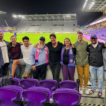 University of Florida Sport Management students with Becky Burleigh at Exploria Stadium, celebrating her final game coaching the Orlando Pride soccer club.