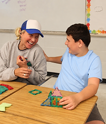 Counselor and camper laughing