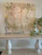Neutral floral abstract painting by Stephanie Evans displayed on a console table.