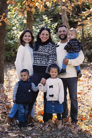 Family of six smiling together during an outdoor fall family photo session