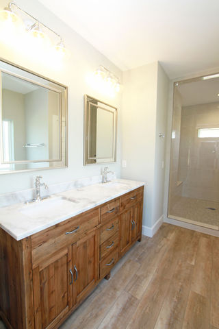 a bathroom with two sinks and two mirrors