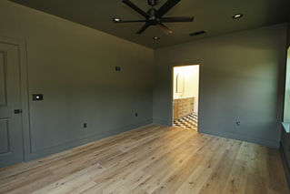 an empty room with a ceiling fan and a black and white checkered floor