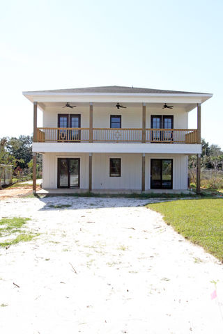 a large white house with a lot of windows and balconies