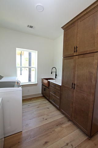 a laundry room with a washer and dryer and a sink