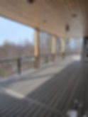 Eye-level view of a modern deck featuring sleek cable railing and rich Trex decking