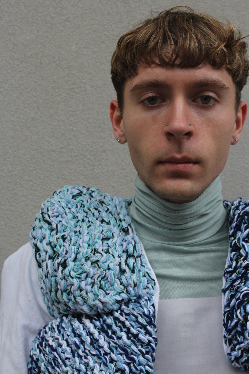 Detail of a garment made with blue wool.