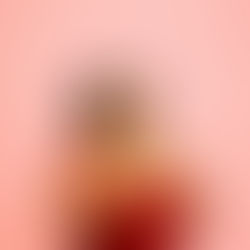 Woman in red dress against pink background, looking up with hands on chest, displaying an anxious expression.