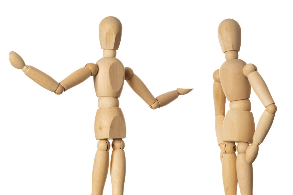Two wooden mannequins on white background. One gestures with open arms, the other stands casually with arms at sides. The image implies that the mannequin gesturing with arms is in conversation with the other mannequin who is standing still, with arms at sides, listening.