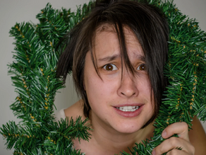 Stressed woman with Christmas wreath around head