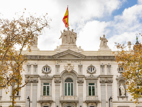 Tribunal Supremo Madrid facade with Spanish flag and neoclassical architecture