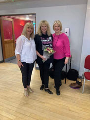 Three people posing for a picture at a dance event