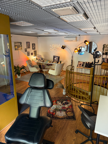 High-end tattoo boutique environment in Helsinki Finland featuring gold decor and professional equipment for safe tattooing.