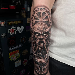 Detailed dark aesthetic warrior captain portrait and nautical ship wheel sleeve tattoo in Finland.