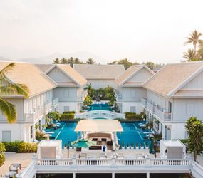 A stunning panoramic view of the longest swimming pool in Luang Prabang, winding through the beautiful villas of MyBanLao hotel