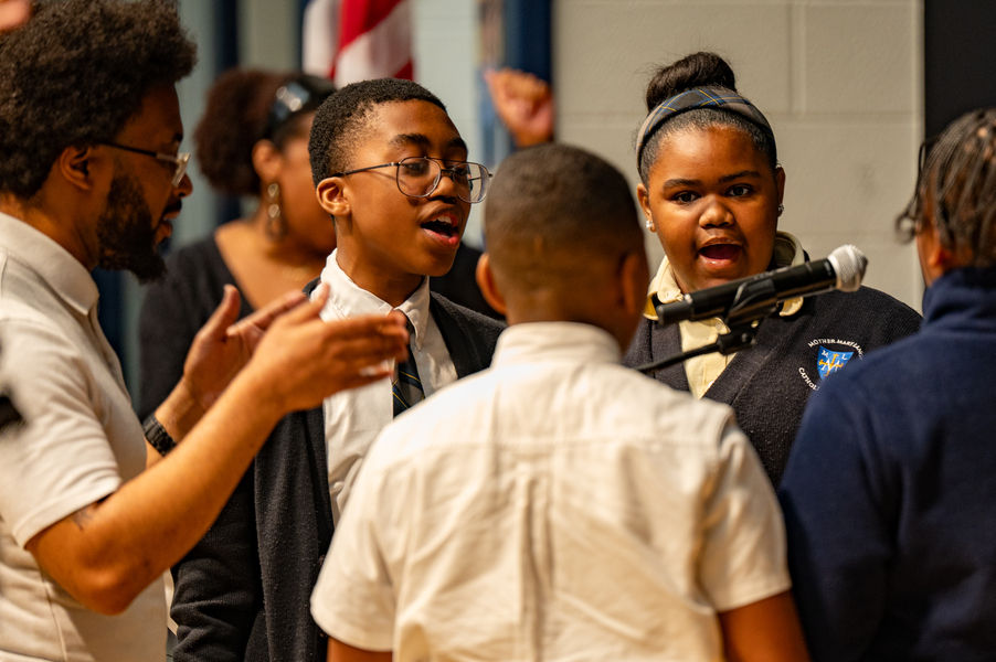 Mother Mary Lange Catholic School music teacher Jason Matthews, left, leads the school choir during a Sept. 24 Mass. Facing the camera are Diron Williams and Marlie James. (Kevin J. Parks/CR Staff)