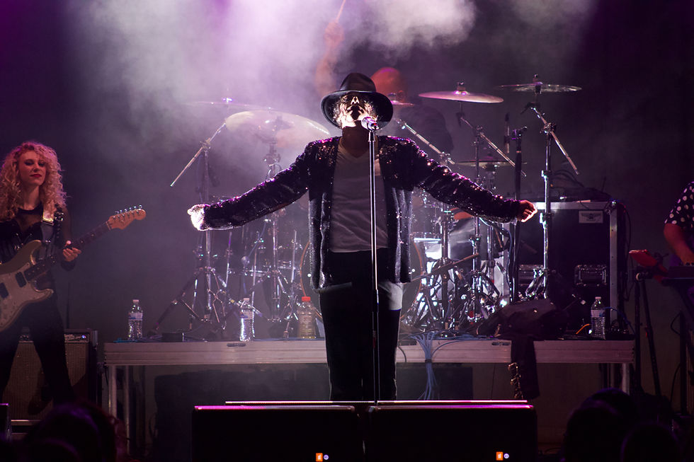 I AM King performing at The Armory. Michael Jackson impersonator posed with arms outstretched.