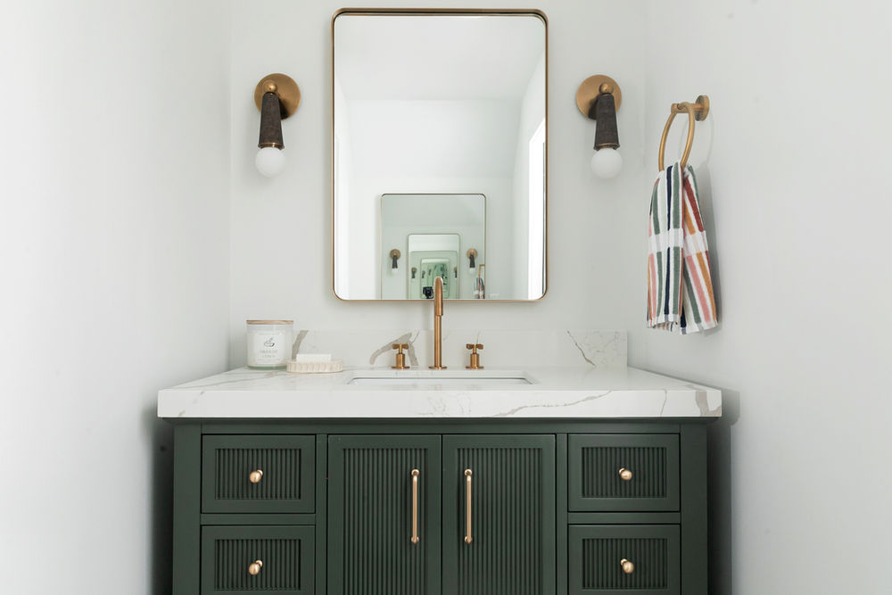 Minimalist powder room with clean lines and warm ambient lighting