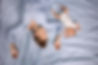 Mom and newborn sleep together in the bedroom on the bed. Joint sleep concept. Tired paren