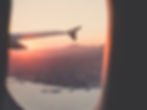 Looking out of plane window onto coastal land