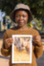 Wild Shots Student Celebrate holding up one of her photographs taken during the course