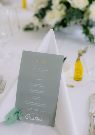 Menu de mariage accompagné d'une décoration florale blanche