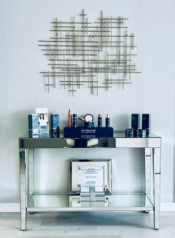 SkinBetter Science products displayed on mirrored console table.