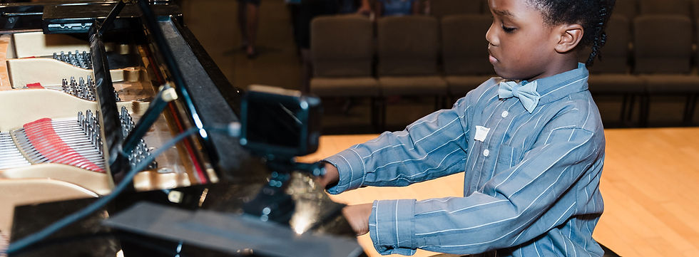 young-boy-playing-piano-at-recital (1).jpeg