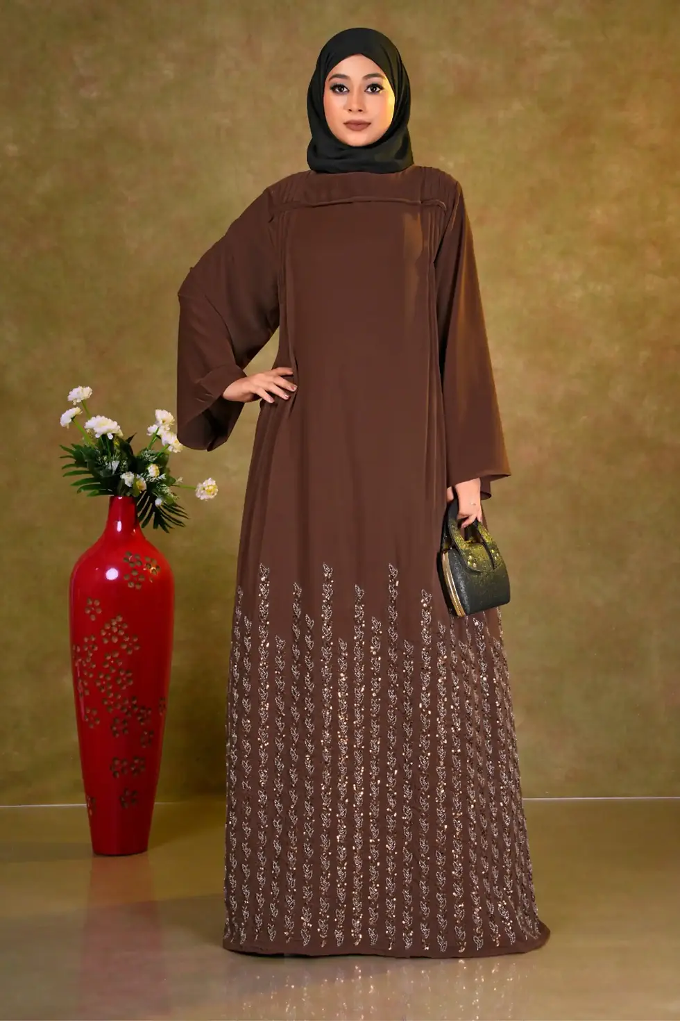 Brown Nida jalabiya with a pleated bodice and a lower panel featuring intricate floral cutwork and shimmering sequins