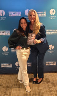 Michele Roys and Mairin Cane pose with a book in her hand