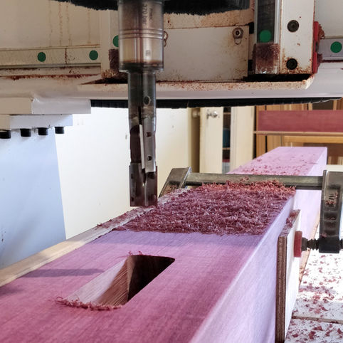 Purple heart timber swimming pool rails and posts being CNC cut.