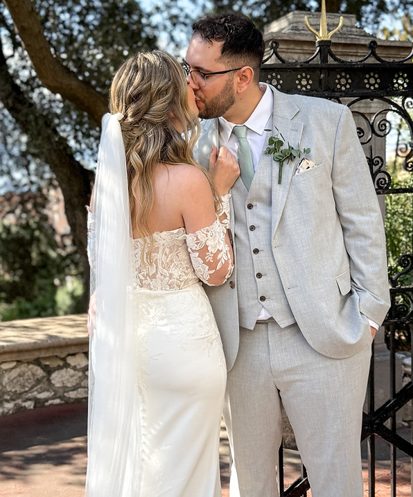 Bride and groom kissing on their wedding day in the Botanic Gardens in Gibraltar