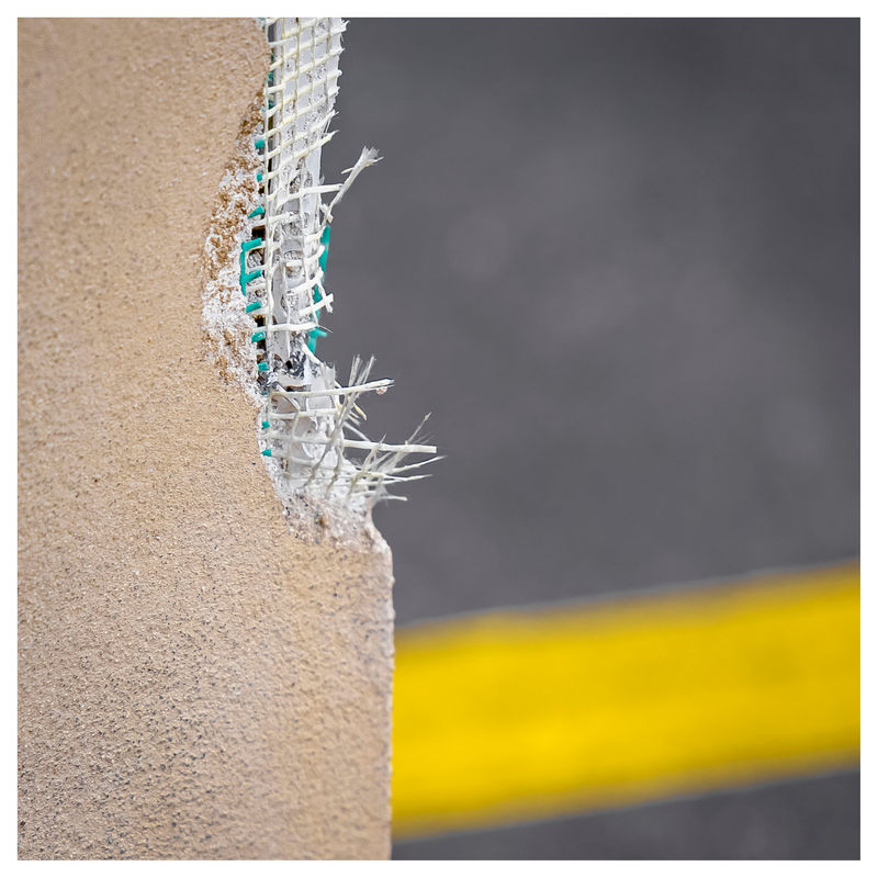 the partly destroyed corner of a wall with the underlying mesh visible
