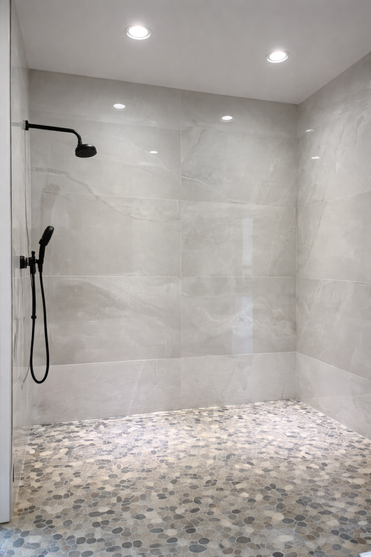 Modern walk-in shower with pebble floor
