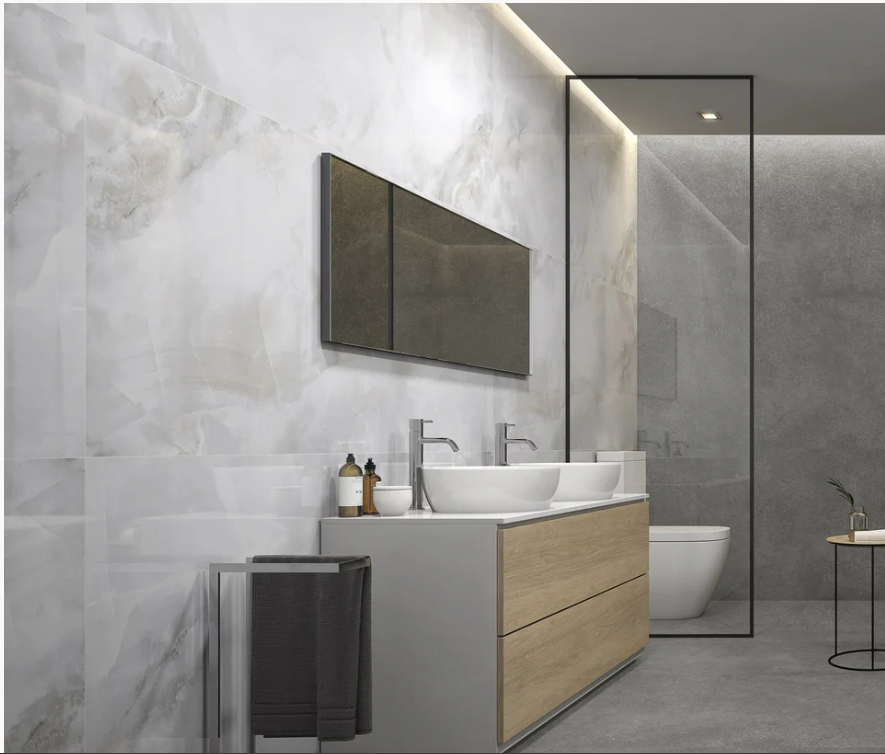 Modern bathroom with double vanity, marble-look wall, and sleek design.