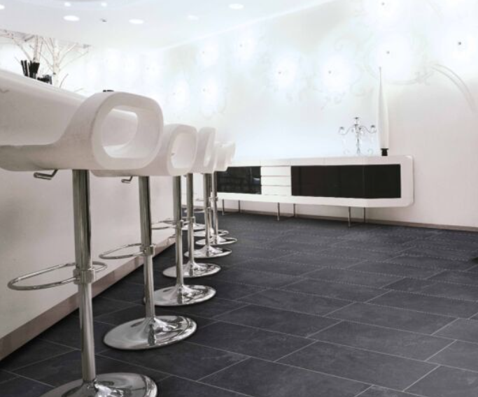 Modern bar stools on dark porcelain tiles