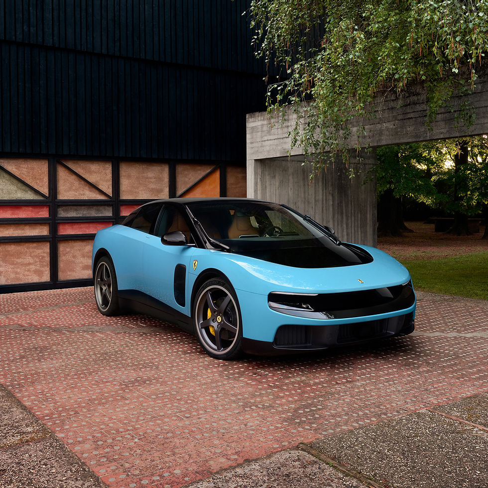 Blue sports car parked on a patterned courtyard beside a modern building, with hanging green vines overhead.