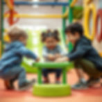 Three children play joyfully around a small round green table.
