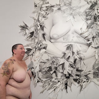 Kristine Schomaker standing nude in a gallery of nude images of herself. Perceive Me Exhibition San Diego, CA