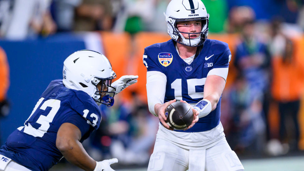 Penn State quarterback Drew Allar hands the ball off to Kaytron Allen.