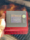 Tappecue Touch screen on Tappecue Stand with grilled meat in the background